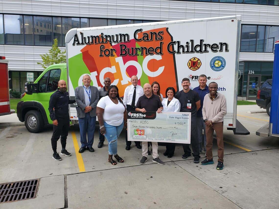 group of donors presenting a donation to Aluminum Cans for Burned Children of Northeast Ohio
