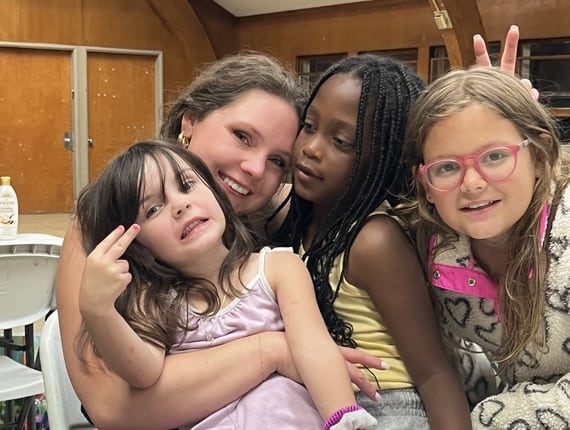 three girls and a volunteer at Camp Phoenix, sponsored by ACBC