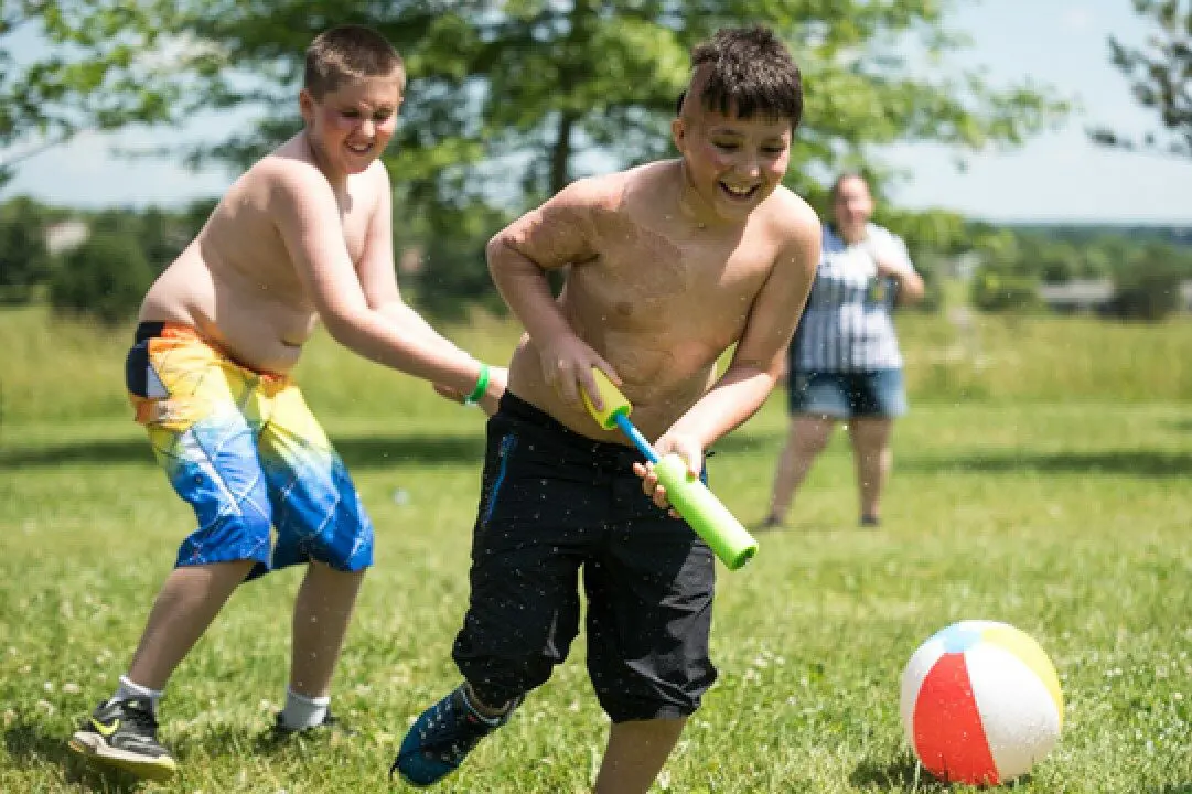 two boys playing at Camp Phoenix's summer camp for children who have suffered burns